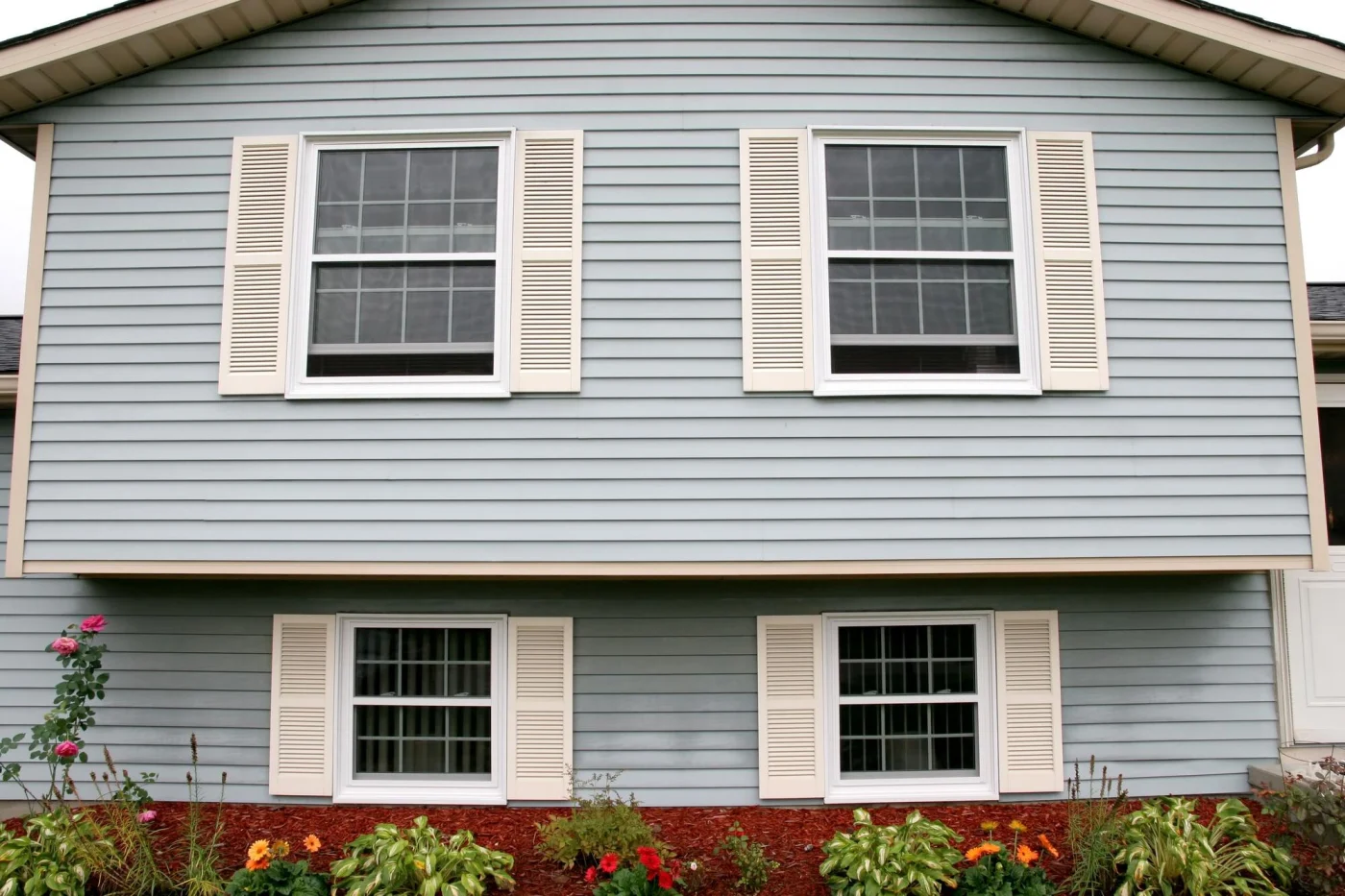 Front of a residential property showcasing expertly installed siding with clean lines.