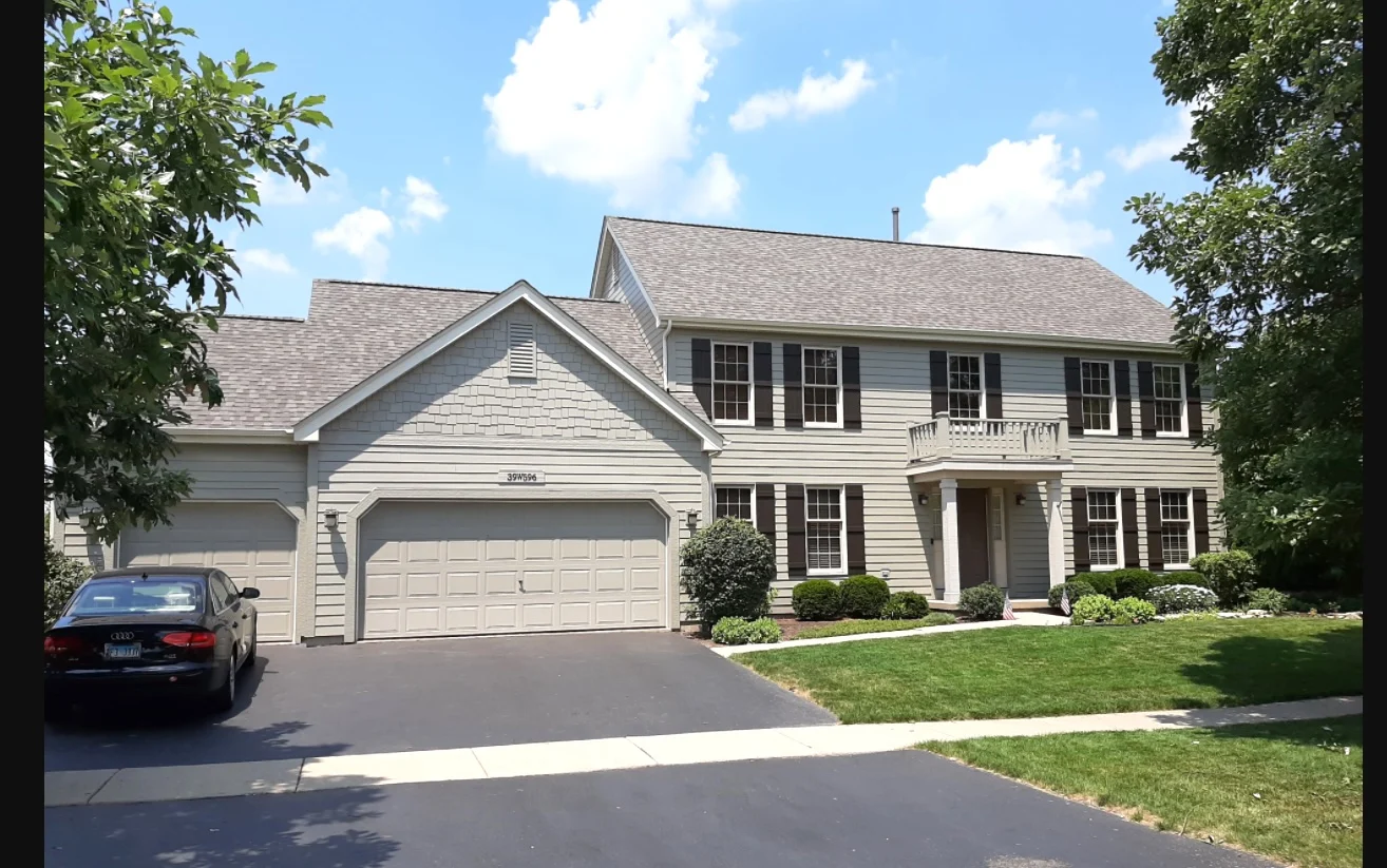 Reliable Roofing Siding Contractor Geneva Il Apex Exteriors A two-story home with white siding and a shingle roof