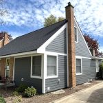 A home with new gray siding and white trim installed by Apex Exteriors.