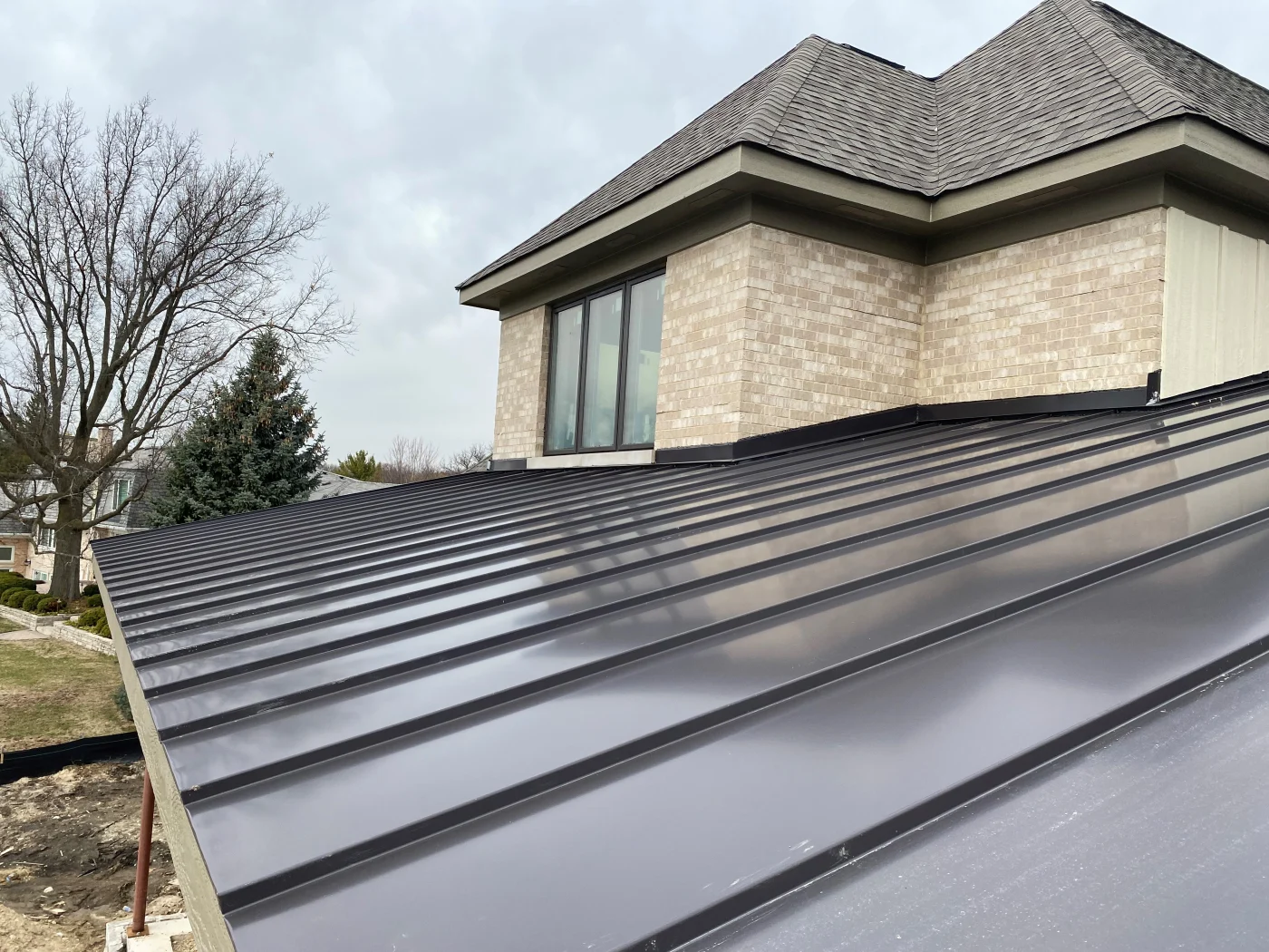 A close up shot of a newly-installed standing seam metal roof.