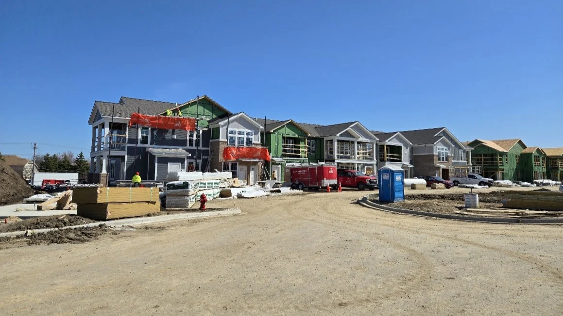 A row of new construction buildings under construction in Elmhurst, IL by Apex Exteriors.