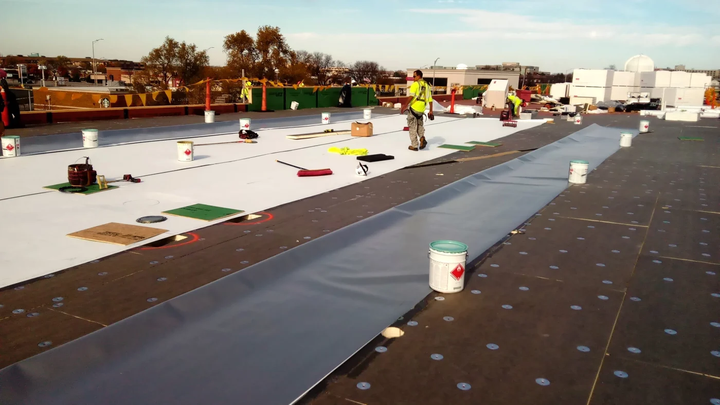The top of a commercial building where roofers are completing a roof installation in Glenview, IL by Apex Exteriors.