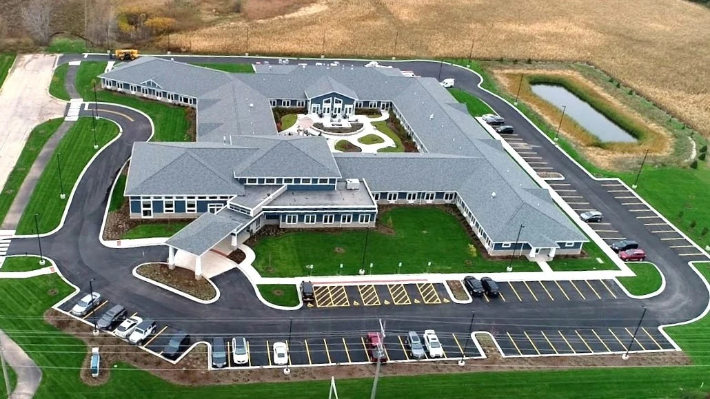 A sky view of a large commercial building with a gray roof in Lombard, IL by Apex Exteriors.