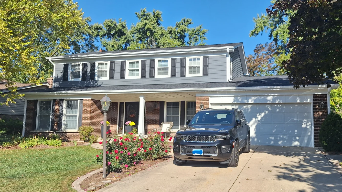 A house with gray siding and a gray roof in LaGrange, IL by Apex Exteriors.
