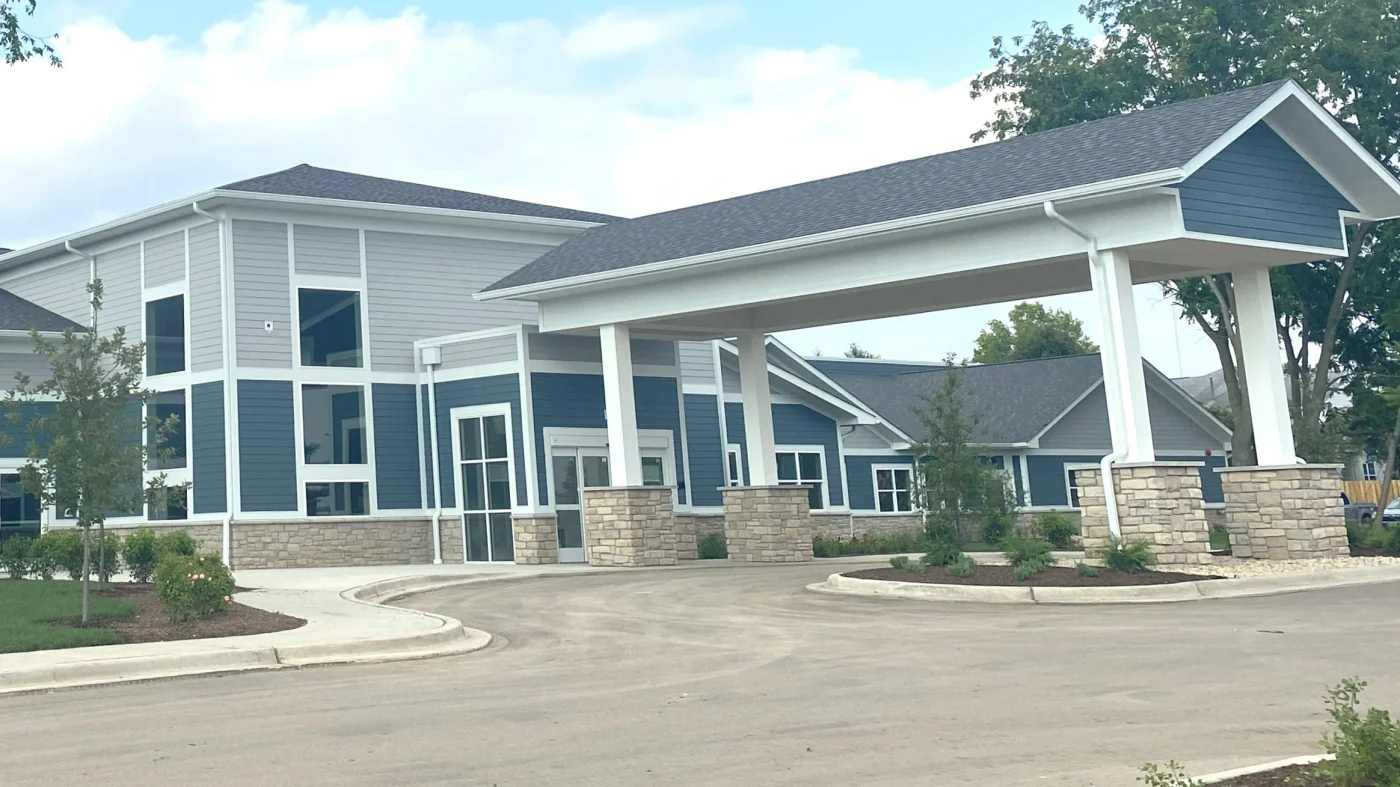 A commercial building with blue and light gray siding with white trim in Lombard, IL by Apex Exteriors.