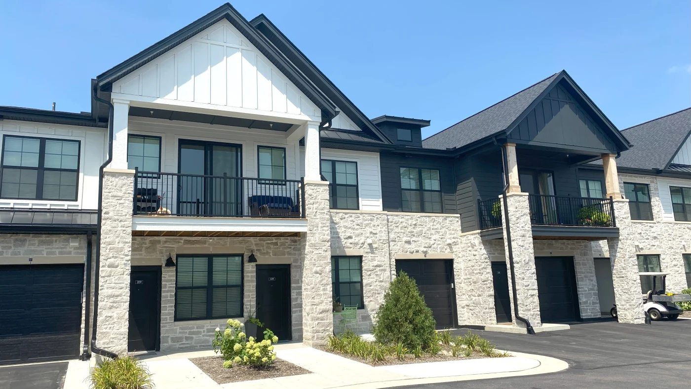 The front of a multi-family housing building with white siding in LaGrange, IL by Apex Exteriors.