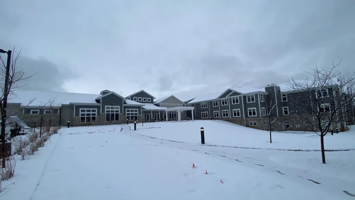 A large multi-family building with blue siding and white trim in Elmhurst, IL by Apex Exteriors.