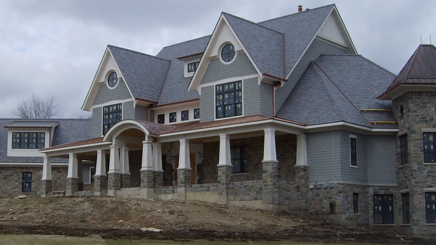 The front of a large house with multi-colored siding in Glenview, IL by Apex Exteriors.