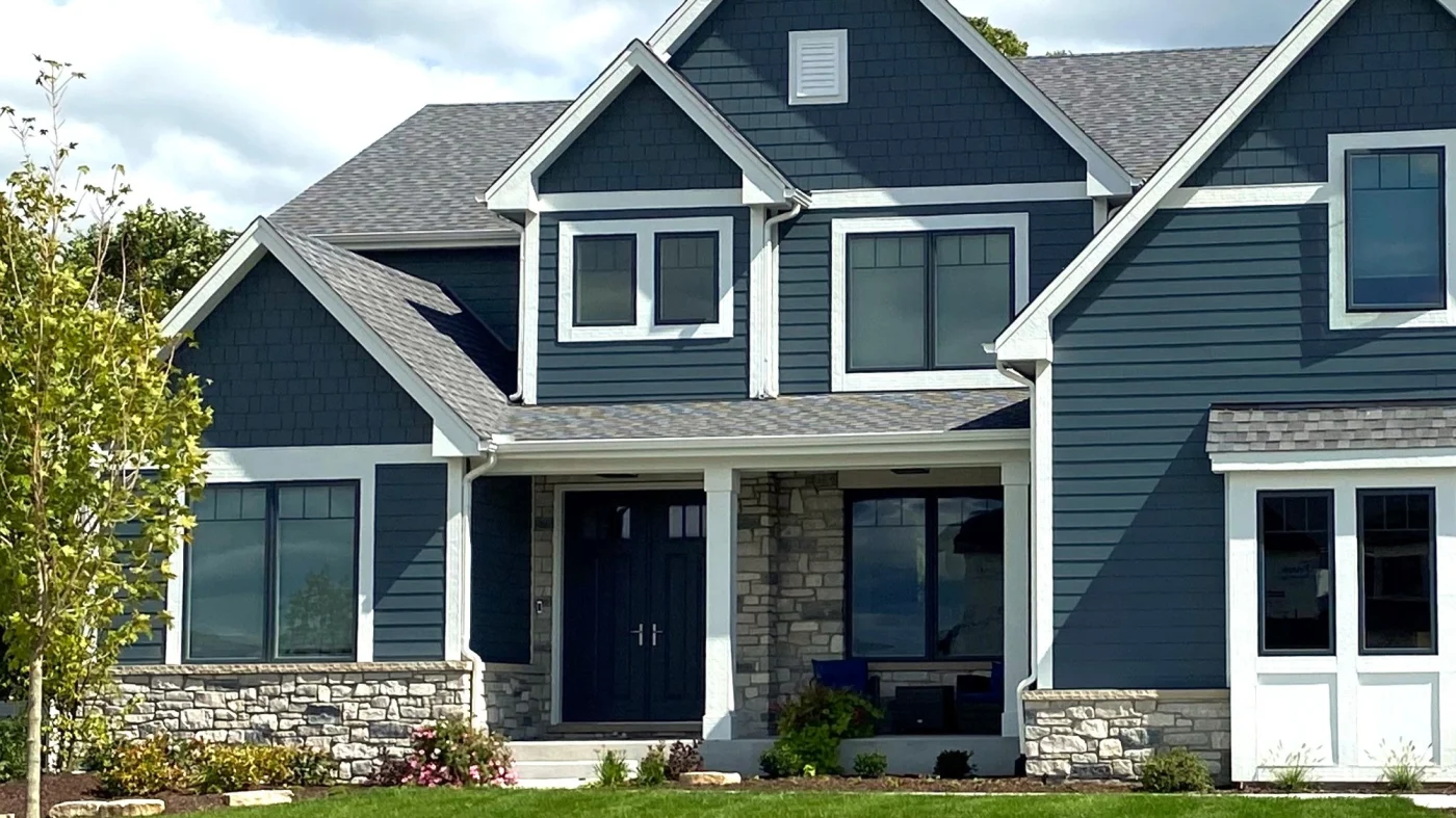 The front of a house with blue siding and white trim in Glenview, IL by Apex Exteriors.