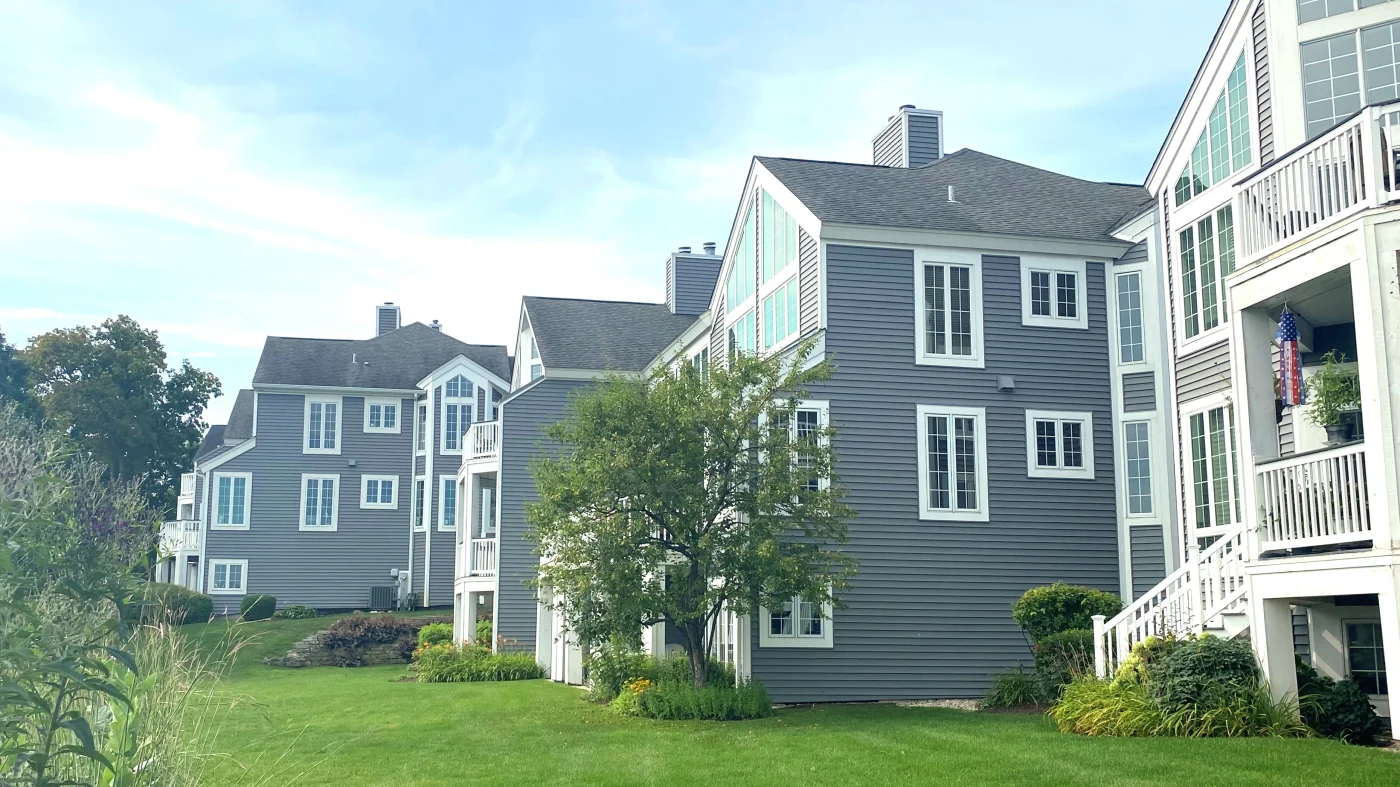 Large housing units in a row, all with slate colored siding in Lombard, IL by Apex Exteriors.