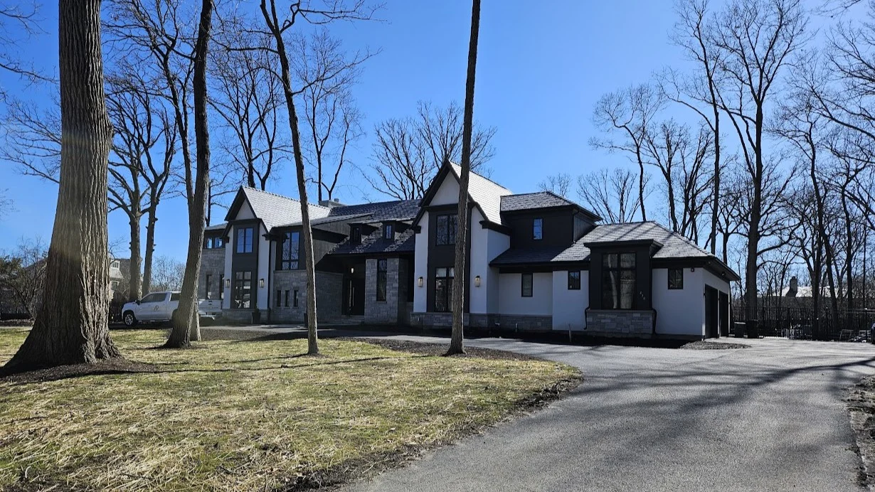The front of a large house with white, light brown, and dark brown siding in Elmhurst, IL by Apex Exteriors.