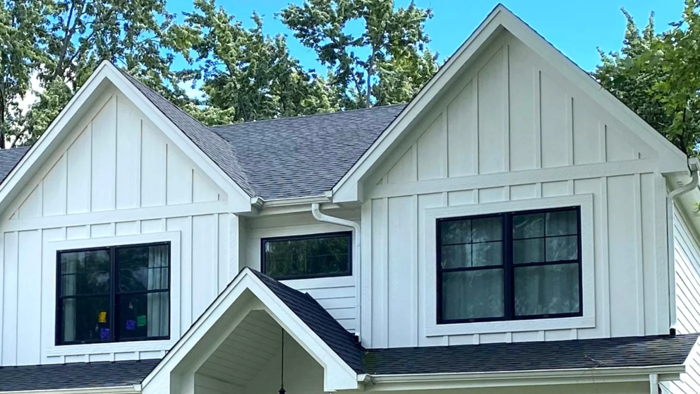 The second floor of a house with white siding and a gray roof in Elmhurst, IL by Apex Exteriors.
