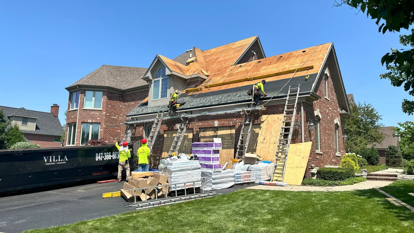 An Apex Exteriors crew is installing a new roof on a house in Lombard, IL.