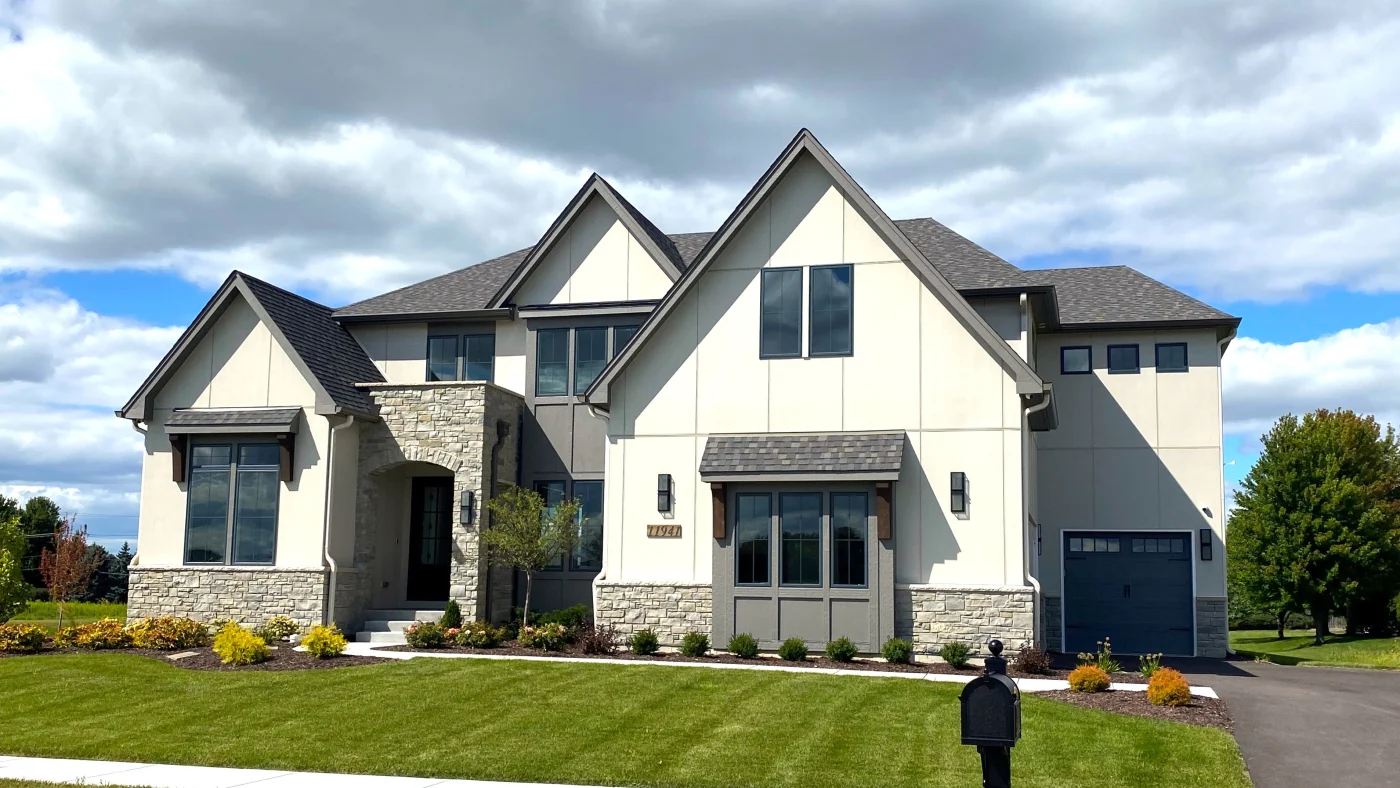 The front of a large home with white siding in Glenview, IL by Apex Exteriors.