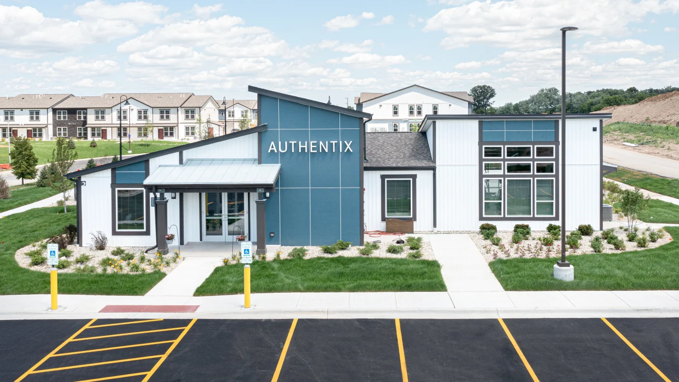 The front of a commercial building with white and blue siding in LaGrange, IL by Apex Exteriors.