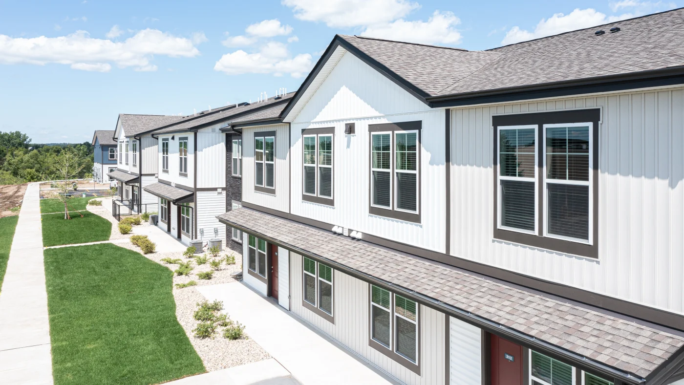 An apartment building with white siding in Glenview, IL, by Apex Exteriors.