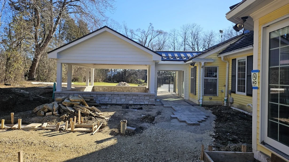The side of a house with yellow siding under construction in Lombard, IL by Apex Exteriors.