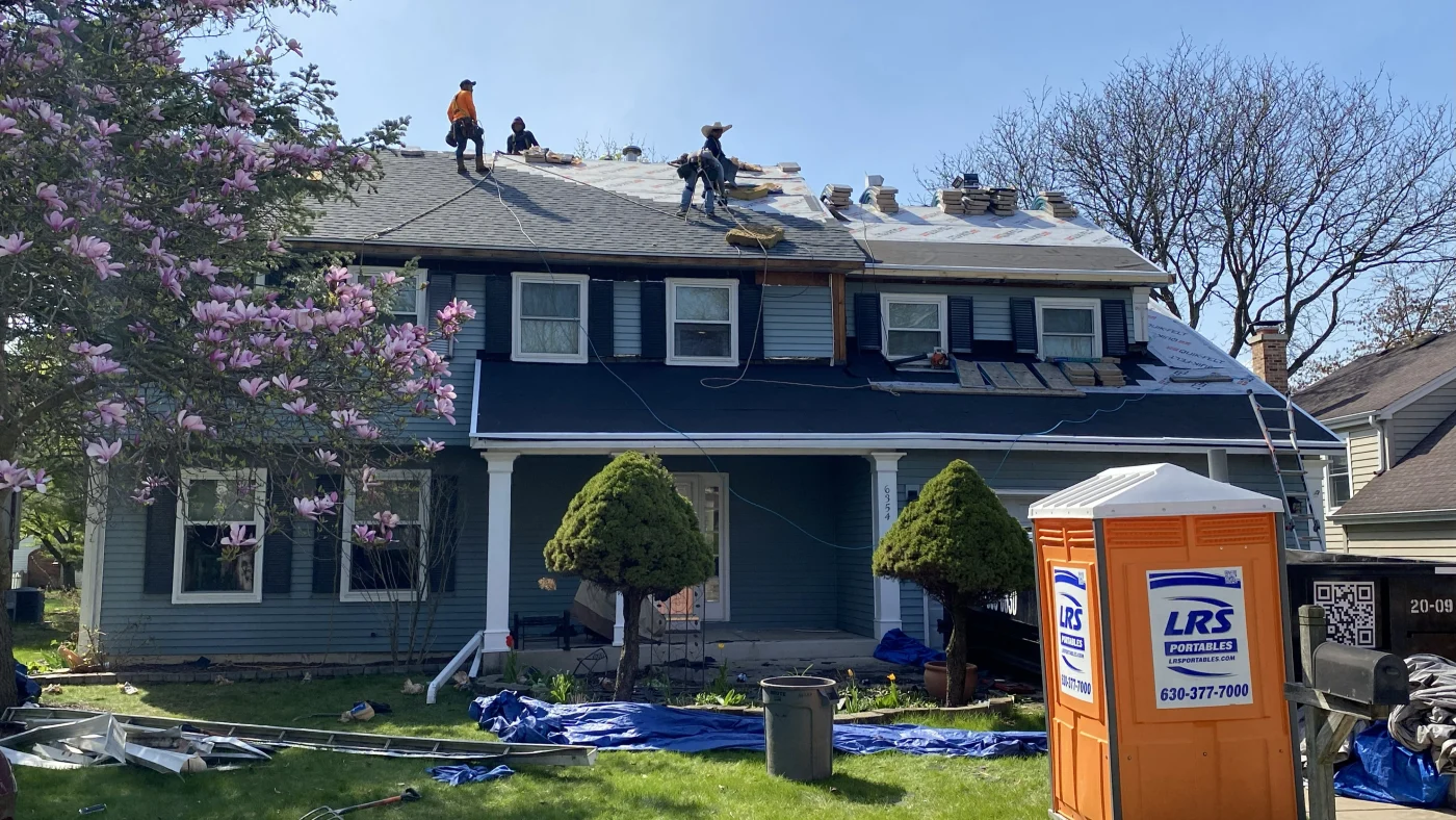 Masterful Roof Replacement Services Deerfield Il Apex Exteriors Inc Apex Exteriors, Inc. crew members are up on the roof of a house installing a new roof in Deerfield, IL