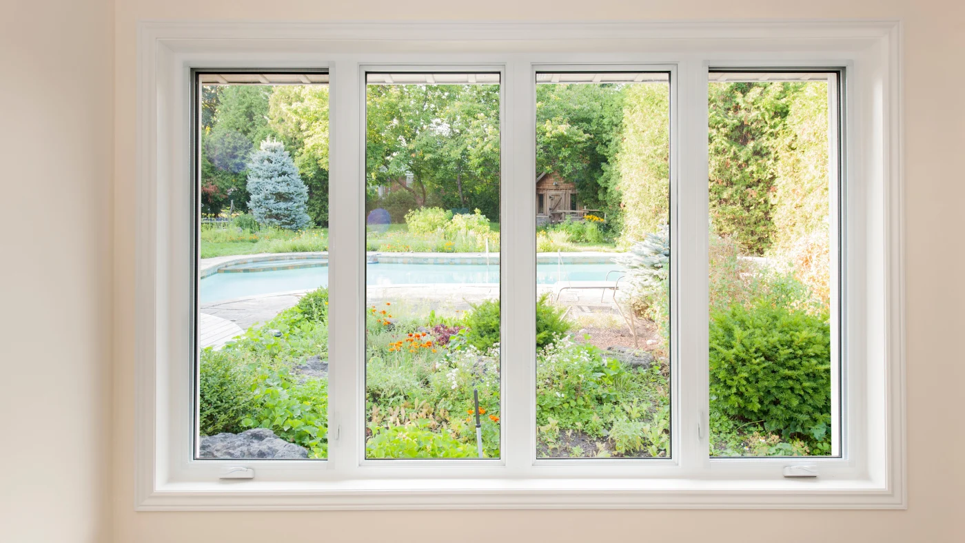 The inside of a home looking outside through a large window with four panels in Naperville, IL by Apex Exteriors.