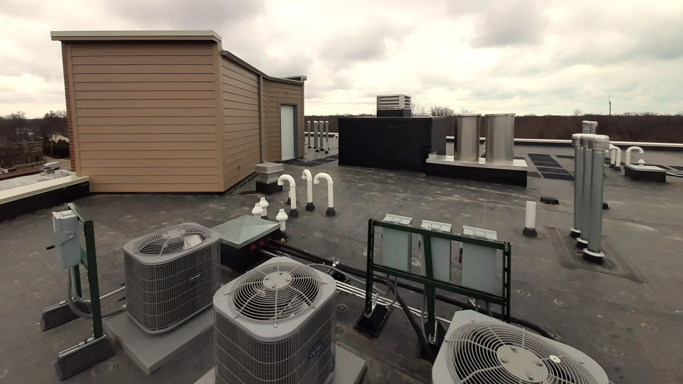 The rooftop of a commercial building with a new addition in Elmhurst, IL by Apex Exteriors.