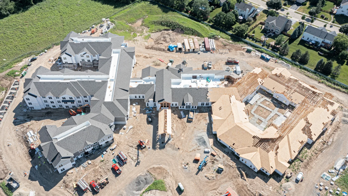 A high-up drone view of a retirement complex under construction in Wheaton, IL by Apex Exteriors.