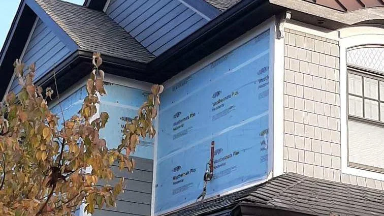 A side of a house during a siding installation in Elmhurst, IL by Apex Exteriors.
