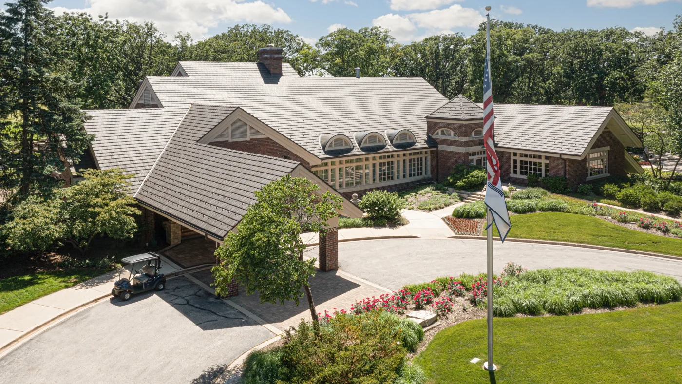 A drone view of a large commercial building with a brown roof in LaGrange, IL by Apex Exteriors.