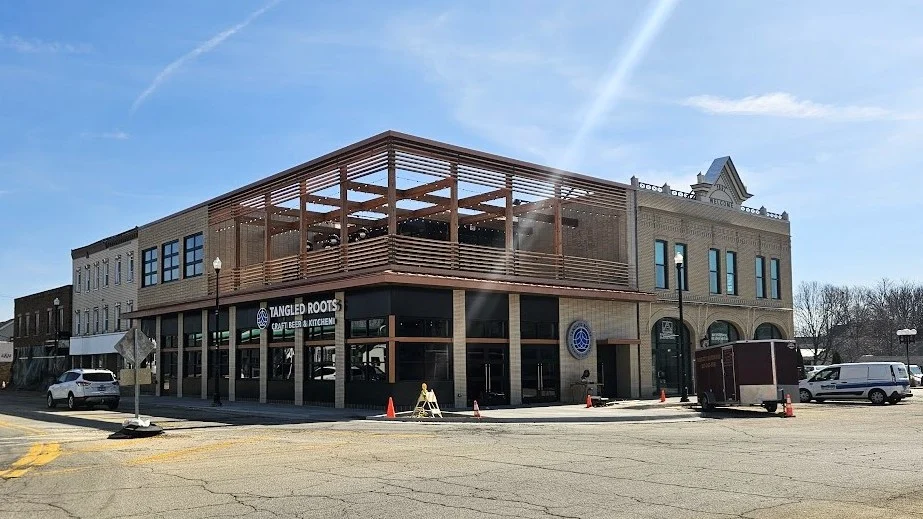 The front of a commercial building with part of the second floor under construction in Bloomingdale, IL by Apex Exteriors.