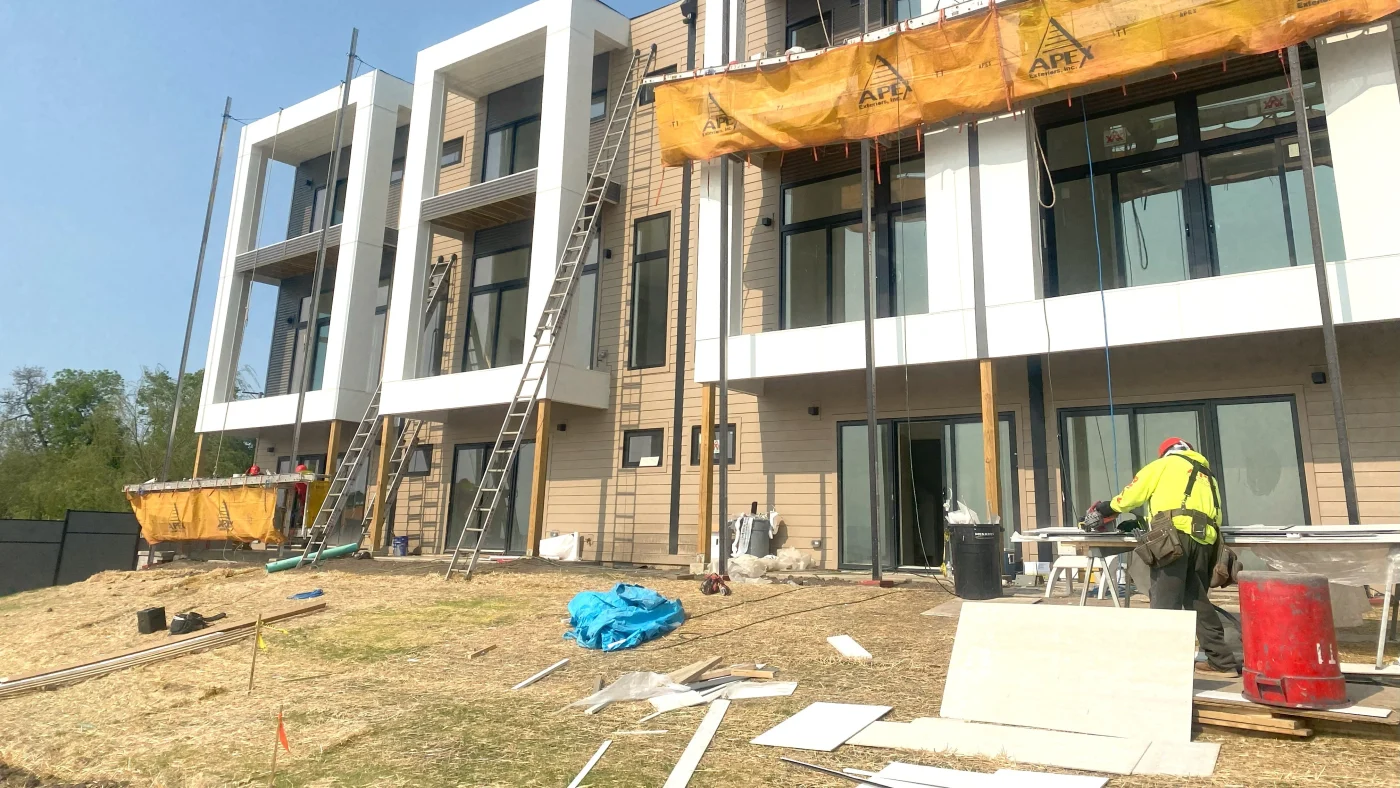 A crew working on a new construction commercial building in Wheaton, IL by Apex Exteriors.