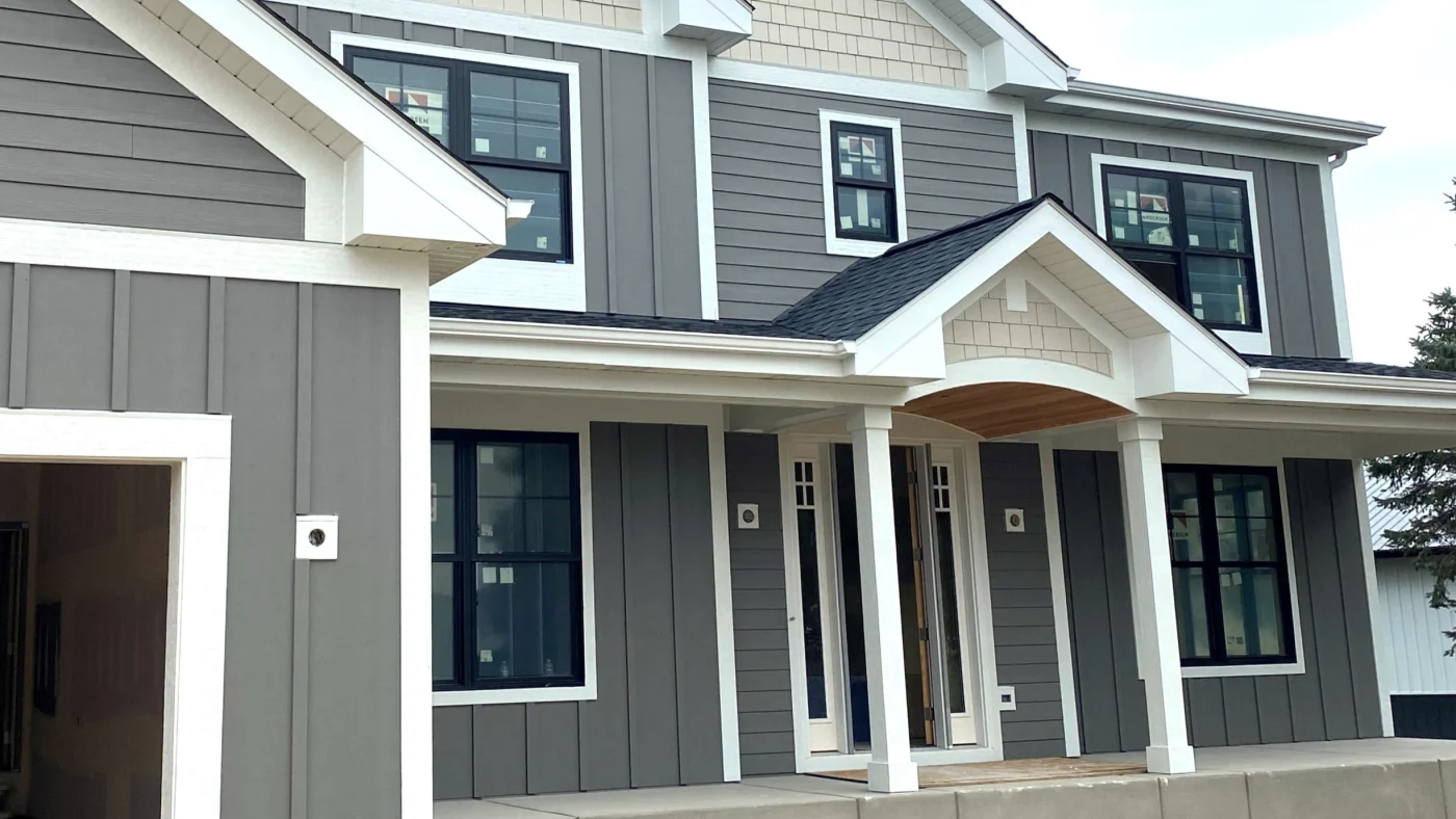 The front of a house with gray siding and white trim in Bloomingdale, IL by Apex Exteriors.