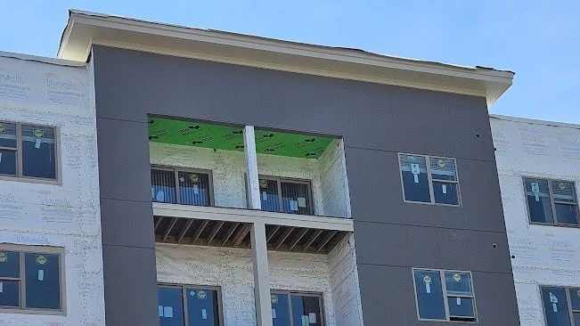 Looking up at a commercial building under construction in Elmhurst, IL by Apex Exteriors.