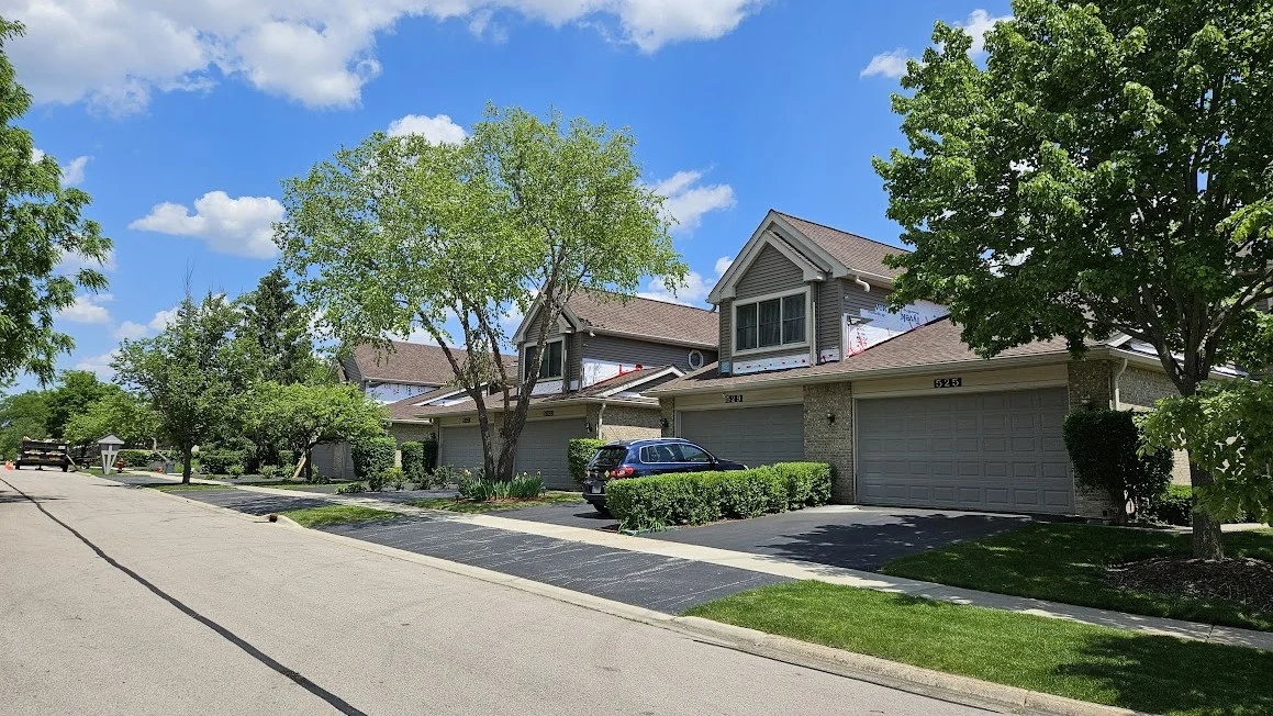 The front of a house from the street with multiple types of siding in Elmhurst, IL by Apex Exteriors.