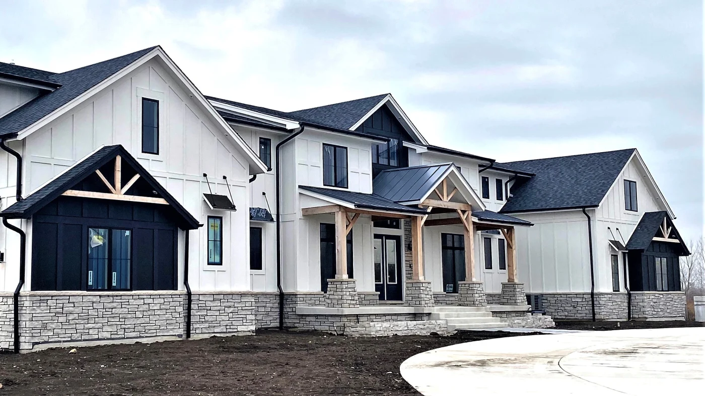 A large house with white siding in Lombard, IL by Apex Exteriors.