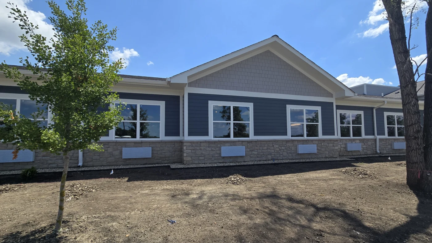 Dependable Commercial Siding Experts | Plainfield, IL | Apex Exteriors, Inc. The backside of a commercial building with three different types of siding in Plainfield, IL, by Apex Exteriors, Inc.