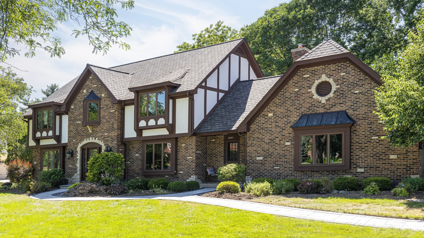 The front of a house with brown siding and a brown roof in Glenview, IL, by Apex Exteriors, Inc.