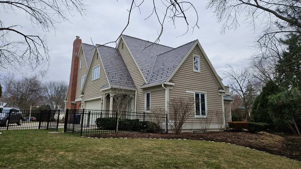 A house with tan siding and a gray roof in Plainfield, IL, by Apex Exteriors, Inc.