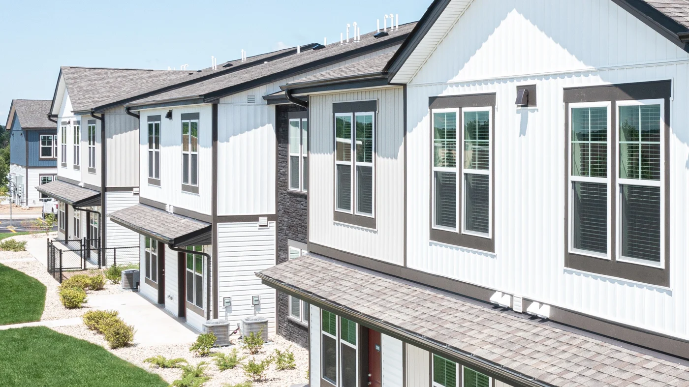 The front of apartment complex buildings with white siding in Elk Grove Village, IL, by Apex Exteriors, Inc.