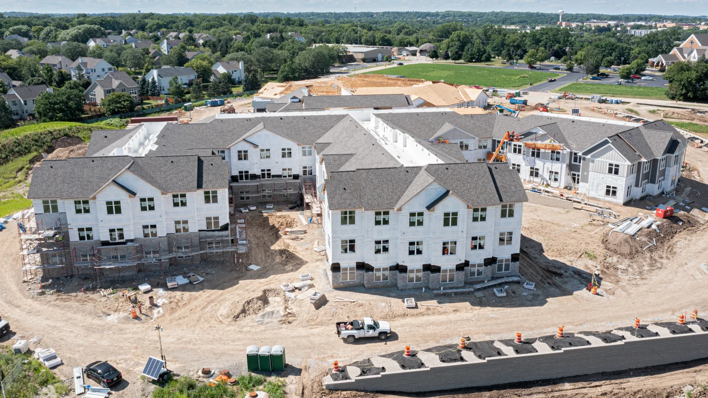 A sky view of multiple apartment buildings close together under construction in Elk Grove Village, IL, by Apex Exteriors, Inc.