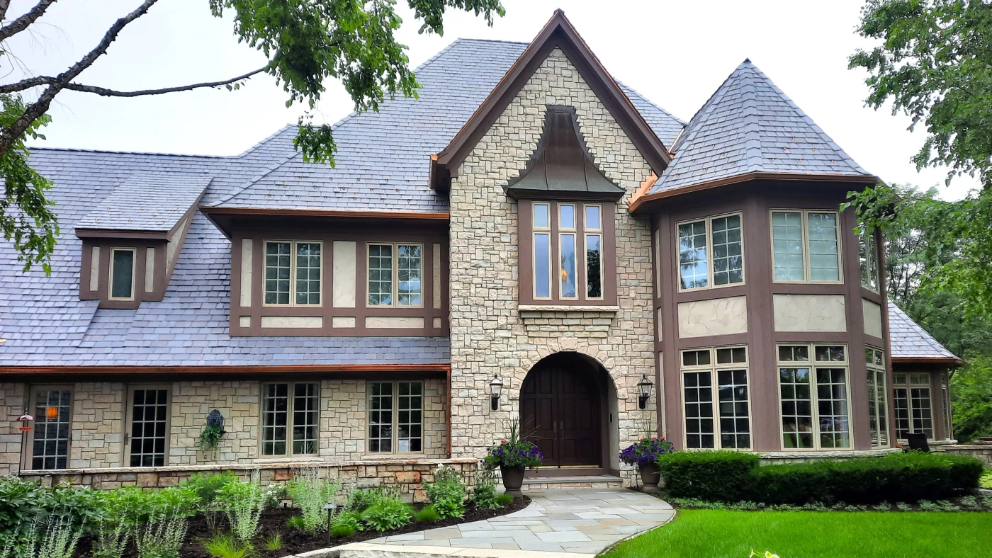 The front of a house with light brown siding and a gorgeous roof in LaGrange, IL, by Apex Exteriors, Inc.