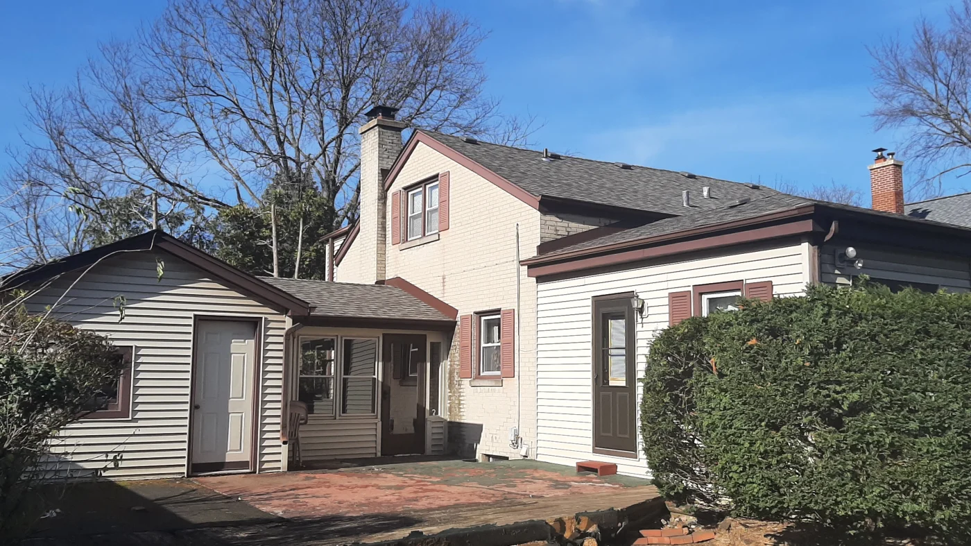 A house with multiple types of siding and a gray roof in Lombard, IL, by Apex Exteriors.