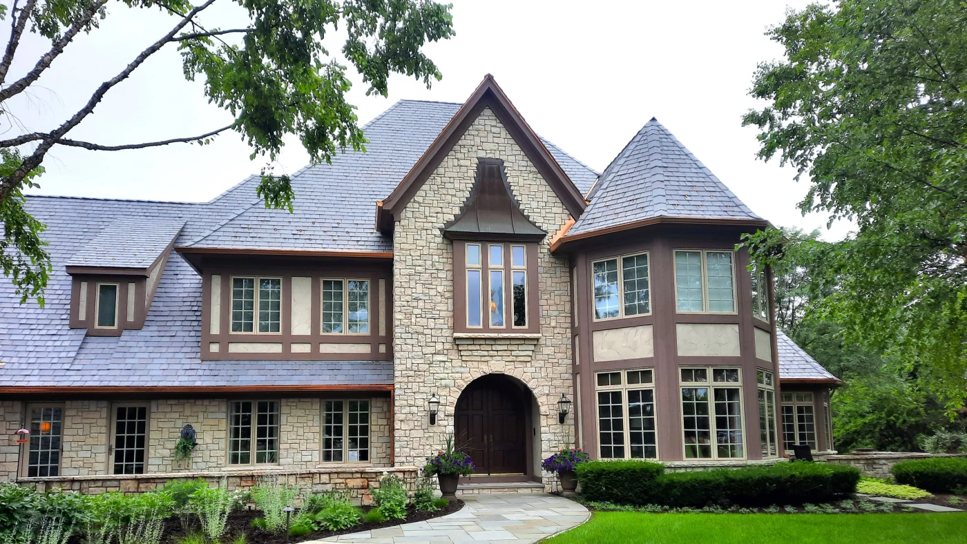 The front of a house with light brown siding in Wheaton, IL, by Apex Exteriors, Inc.