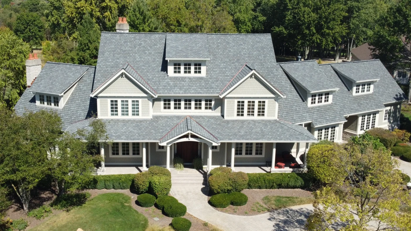 A sky view of a large house with a gray roof in Glenview, IL, by Apex Exteriors, Inc.