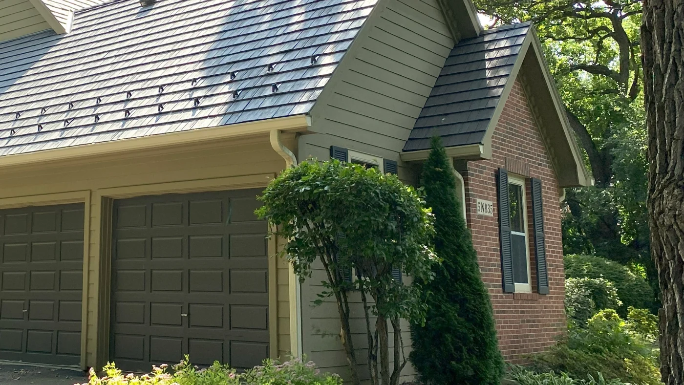 A close-up of a house with multiple types of siding and a dark brown roof in Elk Grove Village, IL, by Apex Exteriors, Inc.