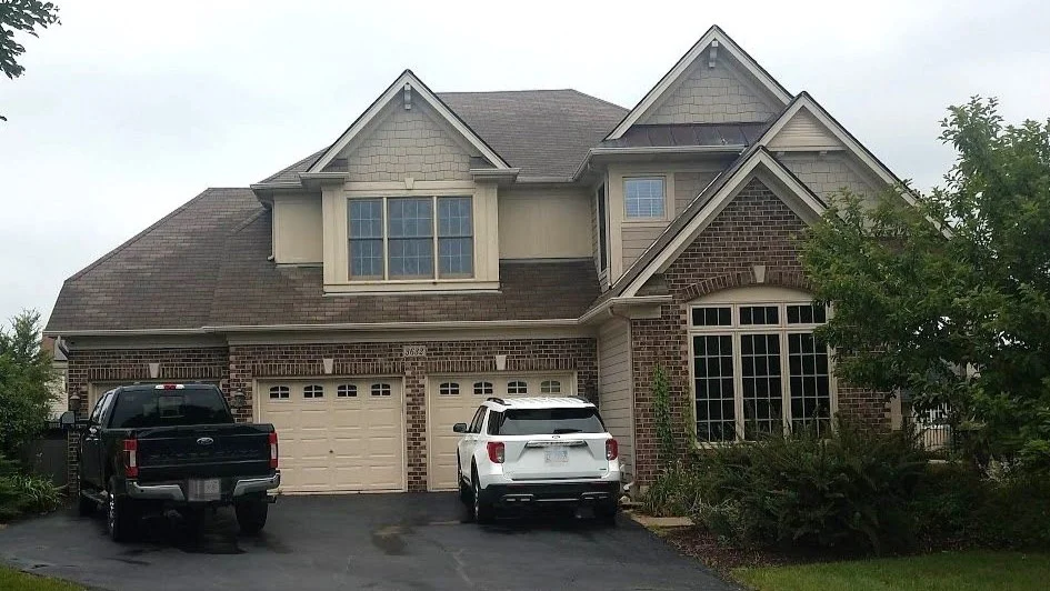 Professional Siding Replacement Services | Deerfield, IL | Apex Exteriors, Inc. The front of a house with brown and beige siding in Deerfield, IL, by Apex Exteriors, Inc.