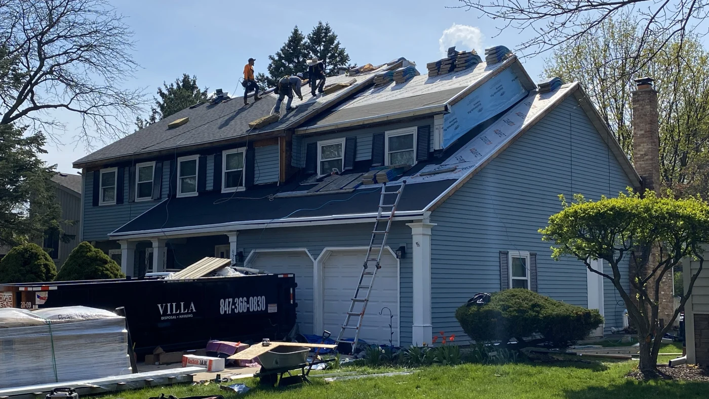 Remarkable Residential Roofing | Plainfield, IL | Apex Exteriors, Inc. Roofers on top of a house installing a new roof in Plainfield, IL, by Apex Exteriors, Inc.