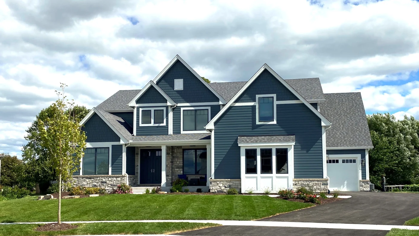 Superb Exterior Services | Plainfield, IL | Apex Exteriors, Inc. The front of a house with blue siding and white trim in Plainfield, IL, by Apex Exteriors, Inc.