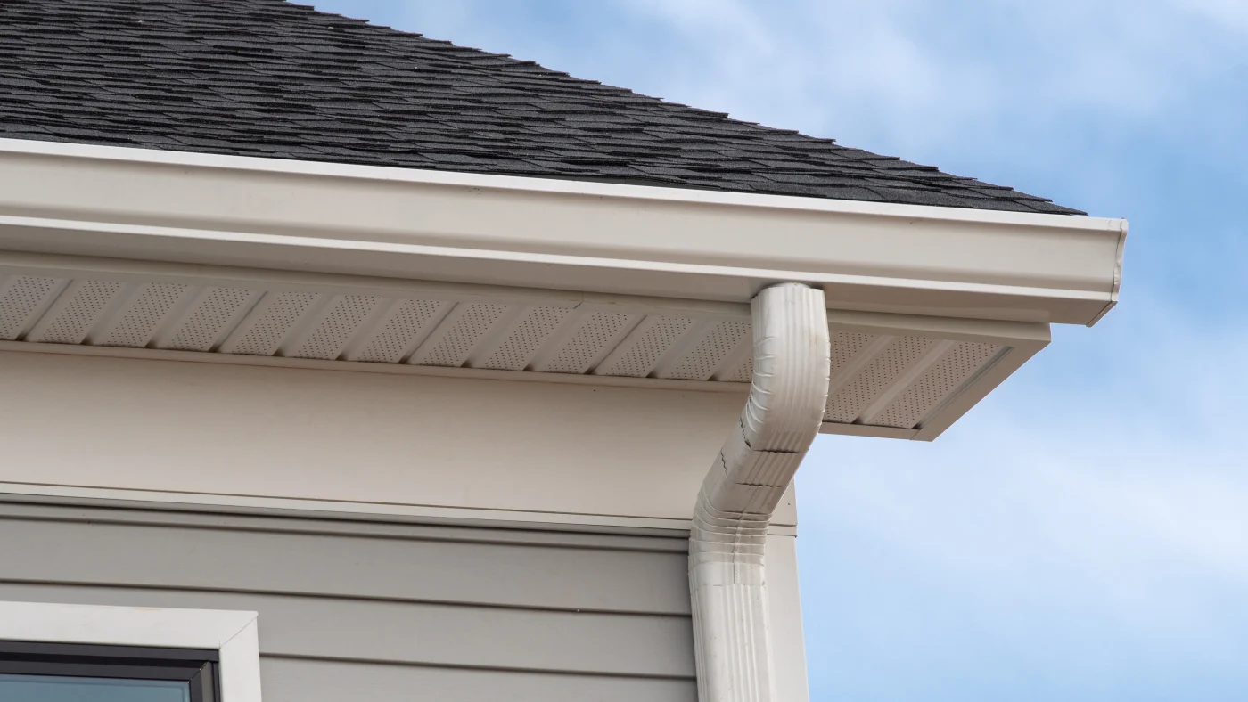Superb Gutter System Services | Plainfield, IL | Apex Exteriors, Inc. A close-up of white gutters on a house with light gray siding in Plainfield, IL, by Apex Exteriors, Inc.