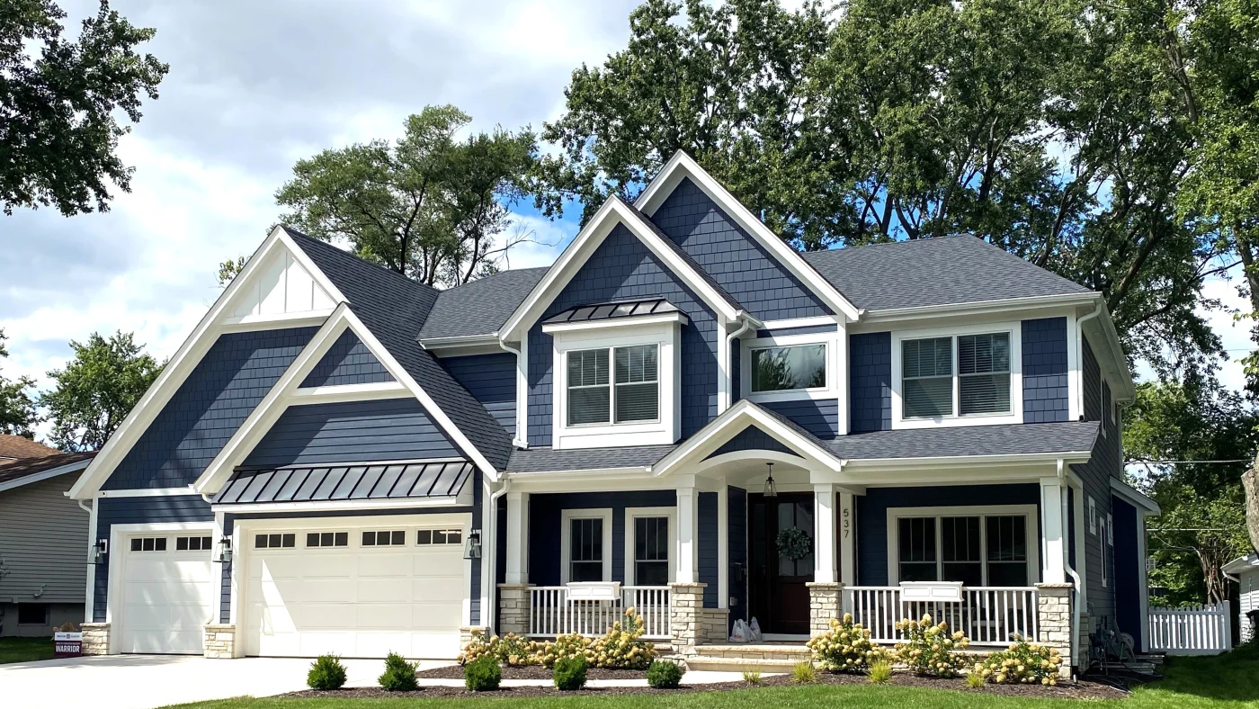 The front of a house with dark blue siding and white siding in Elk Grove Village, IL, by Apex Exteriors, Inc.
