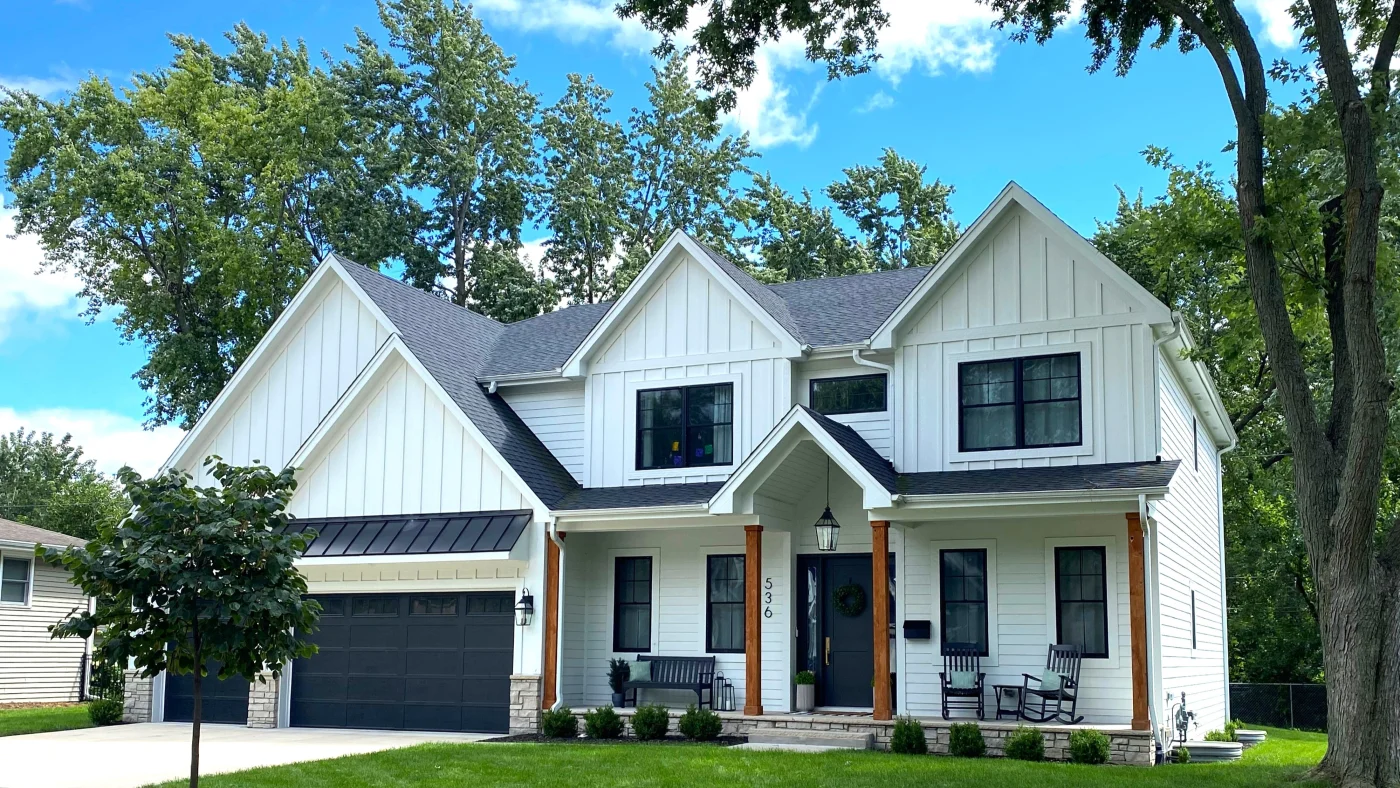 The front of a house with gorgeous white vertical siding and a gray roof in Lombard, IL, by Apex Exteriors, Inc.