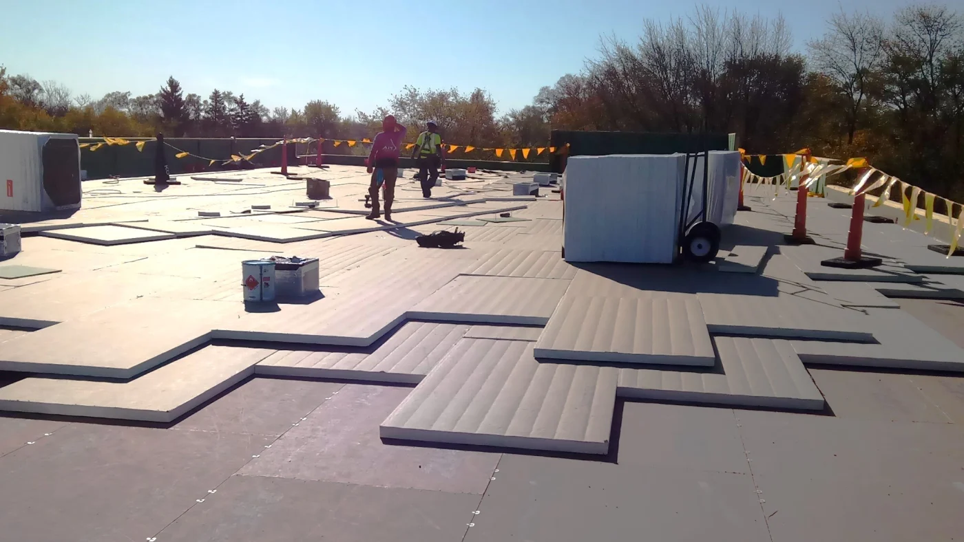Exceptional Commercial Roofing Services | St. Charles, IL | Apex Exteriors, Inc. The roof of a commercial building where Apex Exteiros, Inc. installers are finishing up a roof installation in St. Charles, IL.